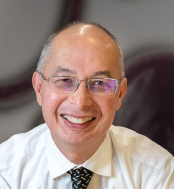 Head and shoulders of Dr Robert Mun, Executive Director, Engineering and Information Sciences, wearing a white shirt and a dark patterned tie.