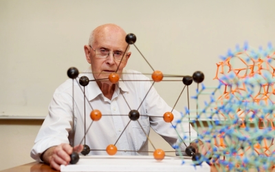 Professor Richard Robson from the University of Melbourne, co-recipient of the 2025 Nobel Prize in Chemistry, sitting in front of a molecular model.