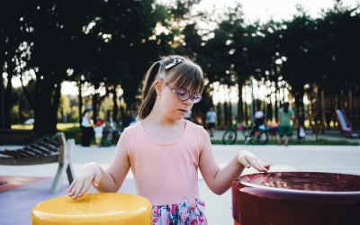 Child with Down syndrome playing at a park. iStock, Vesnaandjic