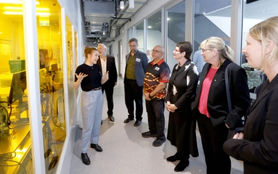 Guests at the FLiQC launch view laboratory facilities during a guided walkthrough at the University of Sydney.