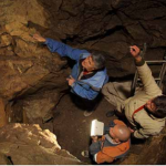 Professor 'Bert' Roberts with Russian colleagues in the east chamber of Denisova Cave