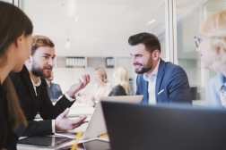 people sitting in an office around a desk