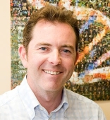 Professor Paul Griffiths Professor Paul Griffiths headshot, standing infront of textured artwork