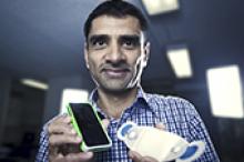 Image caption: Associate Professor Vijay Sivaraman holds a wearable ECG monitoring device.