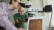 Image: Dr Lu (left) with student Jiong Yang, with the lens on screen.