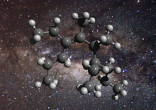 Image: An illustration of the structure of a greasy carbon molecule, set against an image of the galactic centre, where this material has been detected. Carbon is represented as grey spheres and hydrogen as white spheres. Credit: D. Young (2011), The Gala Image: An illustration of the structure of a greasy carbon molecule, set against an image of the galactic centre, where this material has been detected. Carbon is represented as grey spheres and hydrogen as white spheres. Credit: D. Young (2011), The Gala