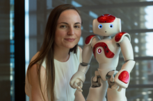 Dr Nicole Robinson with a NAO. Dr Nicole Robinson with a NAO.