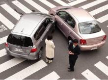 Japanese car accident blur Picture of car crash in the middle of an intersection with two people