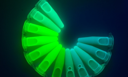 The tuneable emission colour of a solution of various bromide based perovskite nanocrystals under UV light. Credit: Dr Wenping Yin.