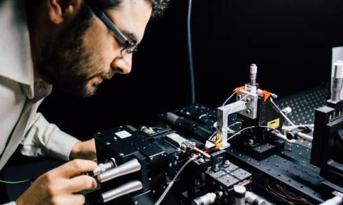 associate Professor Mirko Lobino works on the microchip.