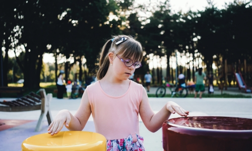 Child with Down syndrome playing at a park. iStock, Vesnaandjic