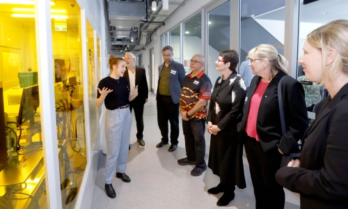 Guests at the FLiQC launch view laboratory facilities during a guided walkthrough at the University of Sydney.