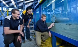 Researchers with subsea pipeline in the lab