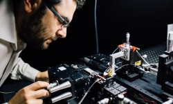associate Professor Mirko Lobino works on the microchip.