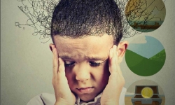 Sad boy with worried stressed face expression looking down.