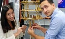 two students holding wires and device