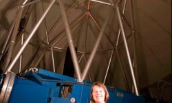 Image: Associate Professor d’Orgeville in front of the Gemini South 8-metre telescope in Chile, during first light propagation of the Gemini South laser using old solid state laser technology (2011) Image credit: Gemini Observatory.