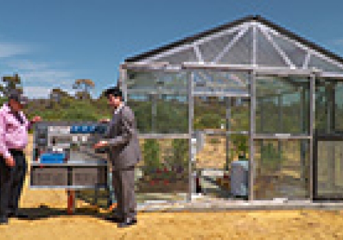 Image: MR Victor Rosenberg, the CEO of ClearVue (left), and Professor Kamal Alameh(right), outside a prototype greenhouse using the new energy harvesting glass, on the ECU campus.