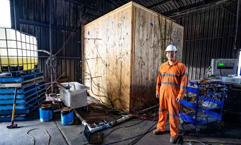 PhD Student, Hangyu Xu, in front of the fire test room. Credit: ARC Future Timber Hub.
