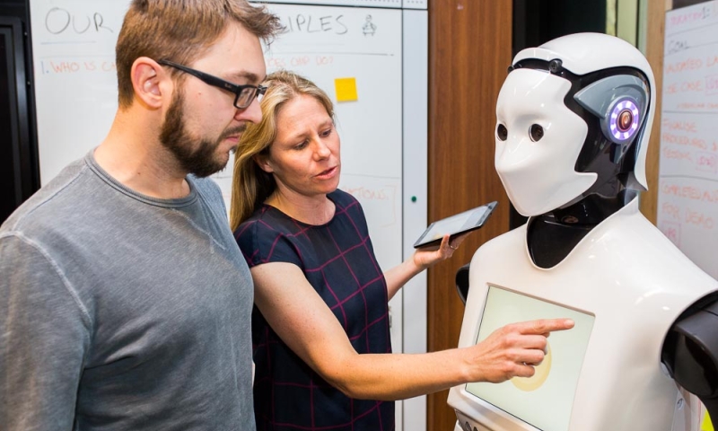 Magic Lab PhD students working in the CBA Innovation Lab on Human-Robot Interaction Experiments with CBA Customers.