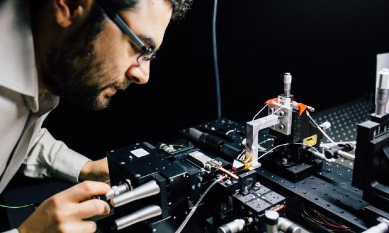 associate Professor Mirko Lobino works on the microchip.
