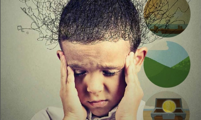Sad boy with worried stressed face expression looking down. 