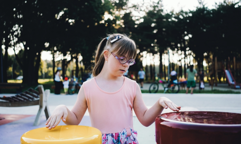 Child with Down syndrome playing at a park. iStock, Vesnaandjic
