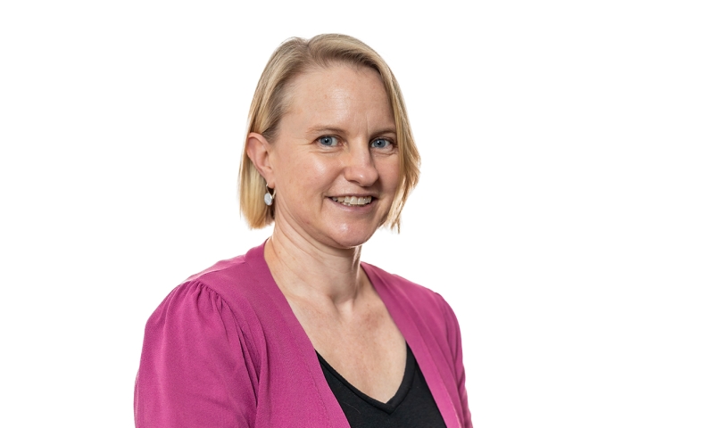 Professor Jennifer Waycott – a person with a blonde bob cut wearing a pink cardigan and black top.