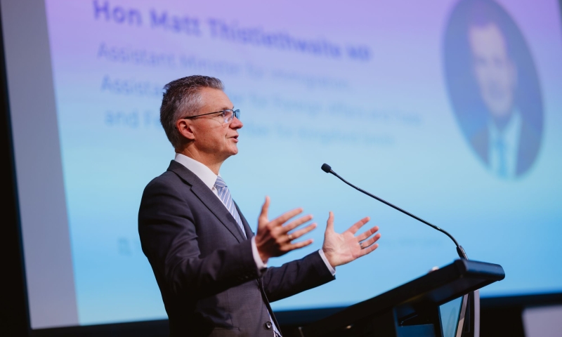 the Hon Matt Thistlethwaite MP addresses the audience from a lectern, speaking at the official launch of the ARC Research Hub for Photovoltaic Solar Panel Recycling and Sustainability.