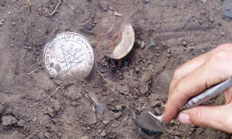 Image: Josephson’s ointment pot lid being excavated from a rubbish pit at the Boralga (Laura), Native Police camp, Cape York. Image credit: Flinders University.